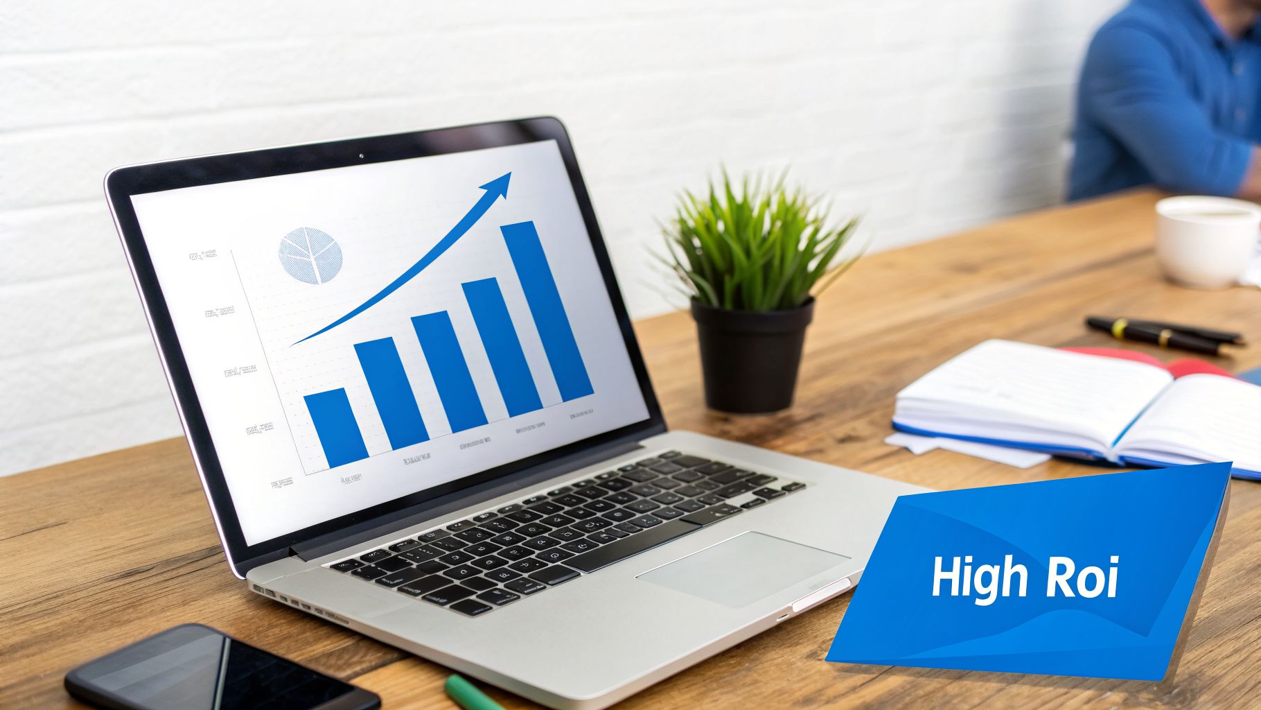 A laptop displays a rising bar graph and pie chart, symbolizing business growth and high ROI on a wooden desk.